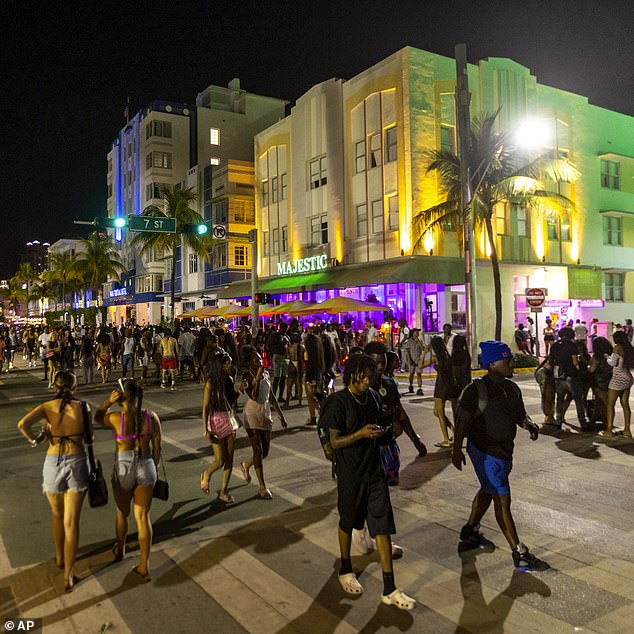 Crowds of people walk up and down Ocean Drive during spring break in Miami Beach on Saturday, March 18, 2023