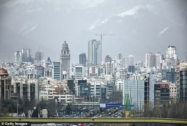 Pictured: The skyline of Tehran, Iran with skyscrapers, pollution and snow-capped Alborz mountains in the background.  Tehran's air pollution described as 'unhealthy'