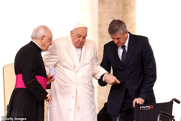 Francis can just make the short walk from his wheelchair to the podium