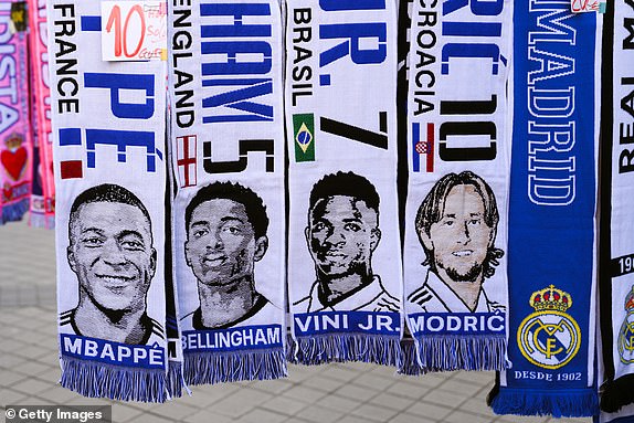 MADRID, SPAIN - MARCH 06: Scarves of Kylian Mbappe, Jude Bellingham, Vinicius Jr.  and Luka Modric hang in a souvenir stall outside the stadium ahead of the UEFA Champions League 2023/24 Round of 16 second leg match between Real Madrid CF and RB Leipzig at Estadio Santiago Bernabeu on March 6, 2024 in Madrid, Spain.  (Photo by David Ramos/Getty Images)