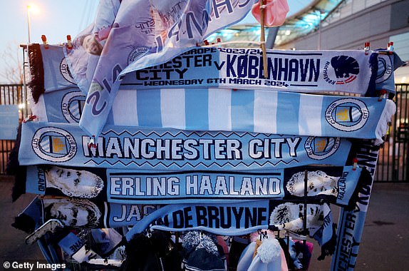 MANCHESTER, ENGLAND - MARCH 06: Manchester City themed merchandise goes on sale outside the stadium ahead of the UEFA Champions League 2023/24 Round of 16 second leg match between Manchester City and FC Copenhagen at Etihad Stadium on March 6, 2024 in Manchester , England.  (Photo by Catherine Ivill/Getty Images)