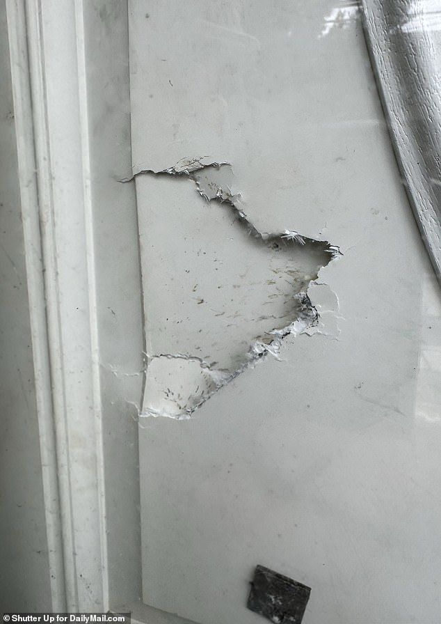 A broken door was visible at the Amityville property, which was raided by police on Monday