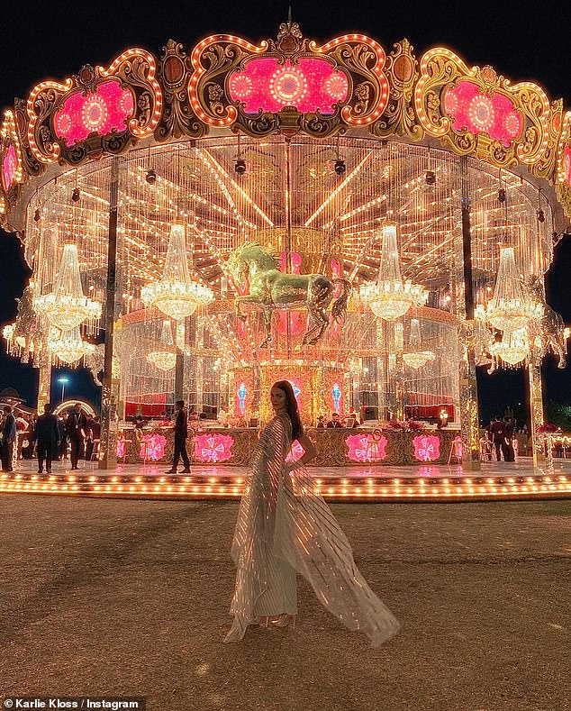 Kloss posted a photo in an iridescent one-shoulder dress as she posed in front of carnival rides at the bash