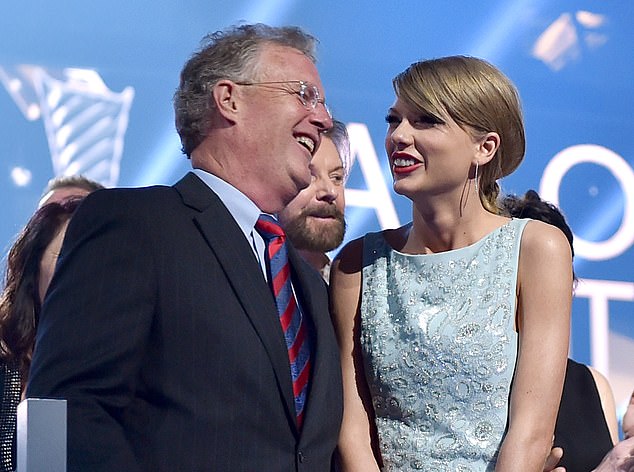 Taylor Swift's father Scott (pictured with her in 2015) was firmly by her side during her tour.  But he has been charged with assault after a run-in with paparazzi in Australia