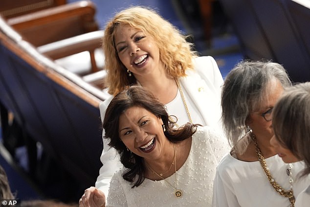 Reps. Norma Torres, D-Calif., back, and Rep. Lucy McBath, D-Ga., back, pictured in their white robes