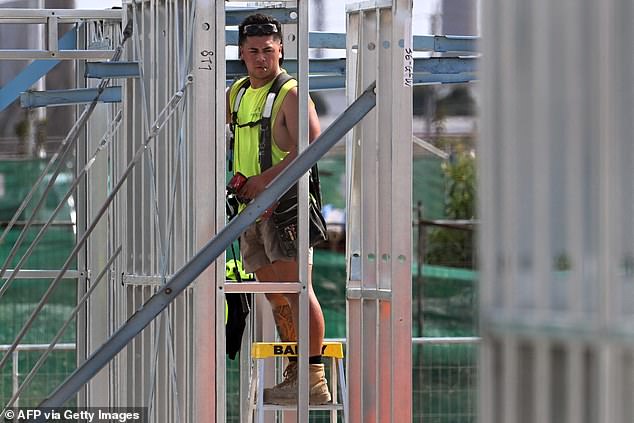 Because the supply of builders is scarce, very few women work as tradies (in the photo a man works at an apartment complex in Melbourne)