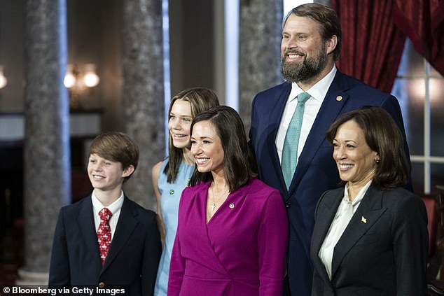Britt pictured with Vice President Kamala Harris with her husband and two children as she was sworn into her U.S. Senate seat on January 3, 2023