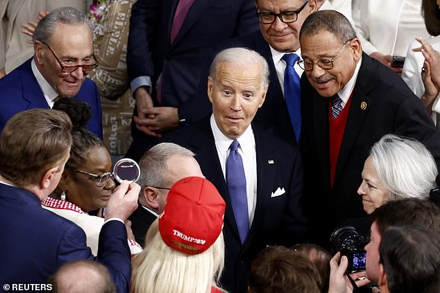 Biden responds while looking at U.S. Rep. Marjorie Taylor Greene