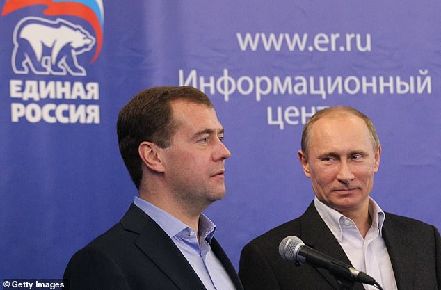 FILE: Russian Prime Minister Vladimir Putin (R) and President Dmitry Medvedev address members of the United Russia Party at the United Russia Party headquarters during a nationwide parliamentary election on December 4, 2011 in Moscow, Russia