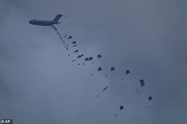 The move follows growing concerns over the level of aid reaching Gaza by land, with international agencies warning of a threat of famine if Israel's current border restrictions on the area continue.  Pictured: Aid is dropped in Gaza, March 8