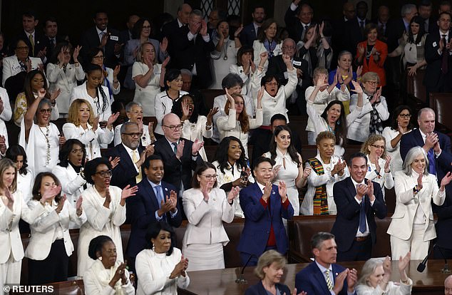 Democratic members of Congress cheer on President Joe Biden during State of the Union address – many Democratic female lawmakers wore white to show their support for reproductive rights