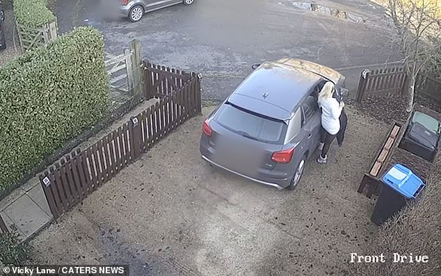 Vicky tries to get into the car as it continues to roll down the driveway