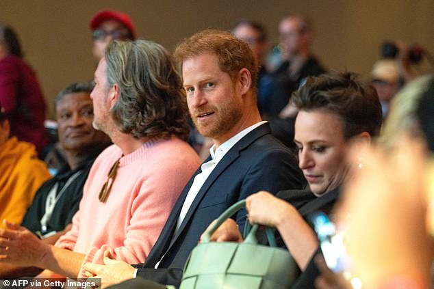 Harry was seen in the front row supporting Meghan - alongside her longtime friend and confidant Markus Anderson