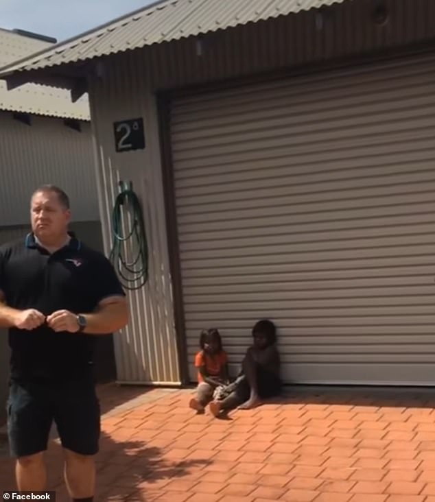 Pictured: Matej Radelic with two children, Margaret and Stuart, tied up in his parents' driveway