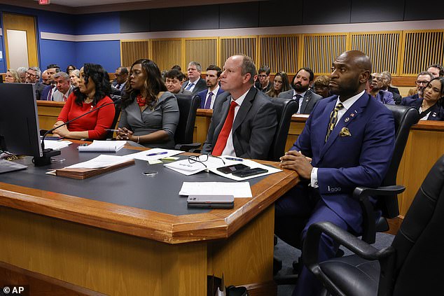 Willis (left) and her ex-boyfriend Wade (right) sit at the prosecutor's table during closing arguments for her March 1 disqualification hearing