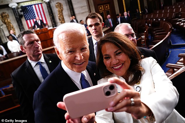 The president poses for a selfie after his final speech before the November elections