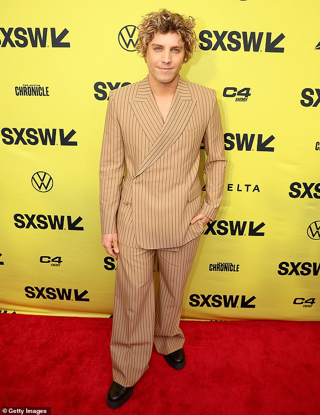 Lukas Gage wore a beige pinstripe jacket and matching oversized pants to the feature film premiere