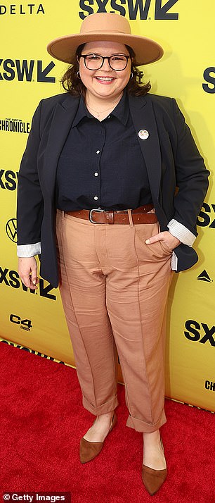 BK Cannon contrasted a black jacket and navy button-up shirt with light orange pants on the event's red carpet.