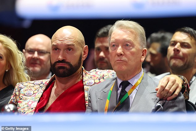 Tyson Fury (left) watched ringside and his reaction to the knockout went viral