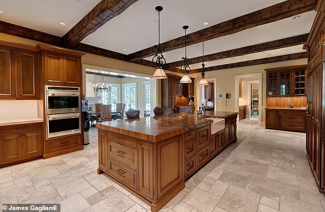 The spacious kitchen includes a large central island, marble countertops and top-of-the-line appliances