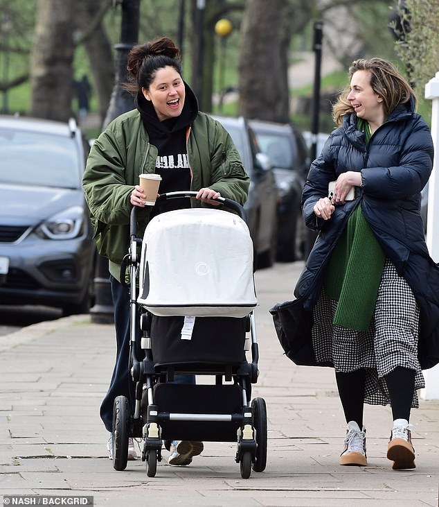 The singer, best known for her hits Pack Up and Skinny Jeans, was seen pushing her baby in a stroller while chatting to her friend Helen.