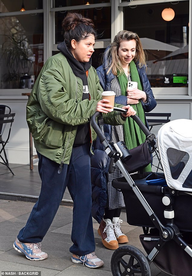 To wrap up against the cold weather, Eliza opted for a green jacket, hooded top and sweatpants