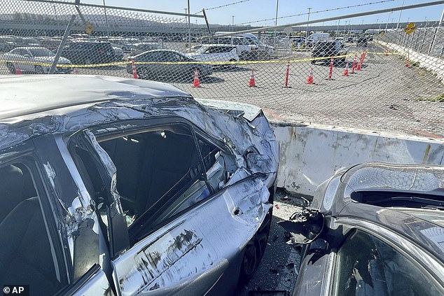 Cars written off by the falling wheel are now nothing more than twisted metal