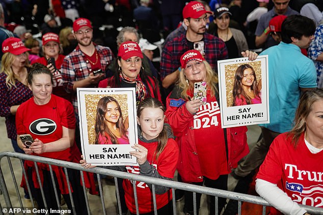 Attendees at the Trump rally at the Forum River Center in Rome, Georgia on Saturday, March 9, 2024, hold posters depicting 22-year-old Laken Riley.  An illegal immigrant was charged with her murder