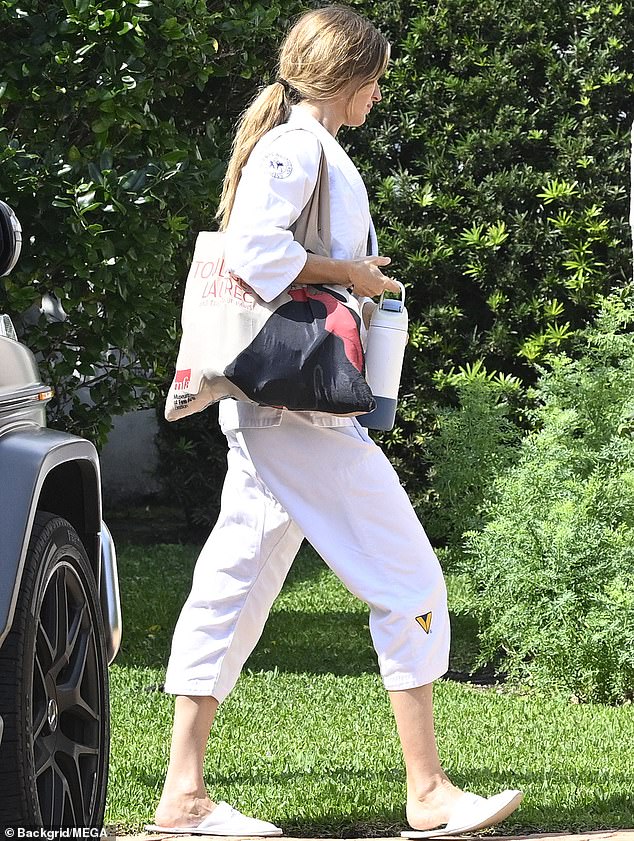 At another point, she was seen running errands in a white sweater with a matching blouse, her caramel hair in a ponytail.