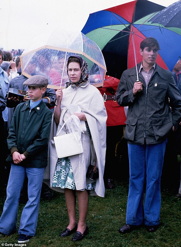 Queen Elizabeth II, Prince Andrew and Prince Edward don't let the rain deter them as they attend the July 1976 Olympic Games in Montreal, Canada