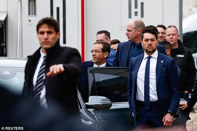 Israeli President Isaac Herzog leaves after a visit to the National Holocaust Museum on the day of its opening