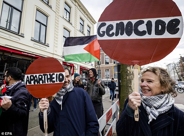 Protesters carry signs during a demonstration calling Israel's military campaign in Gaza 'genocide'