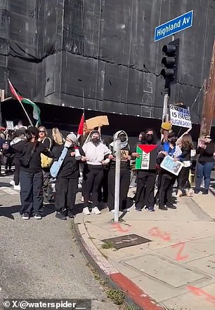 There was a crowd at the intersection of Highland Avenue and De Longpre Avenue