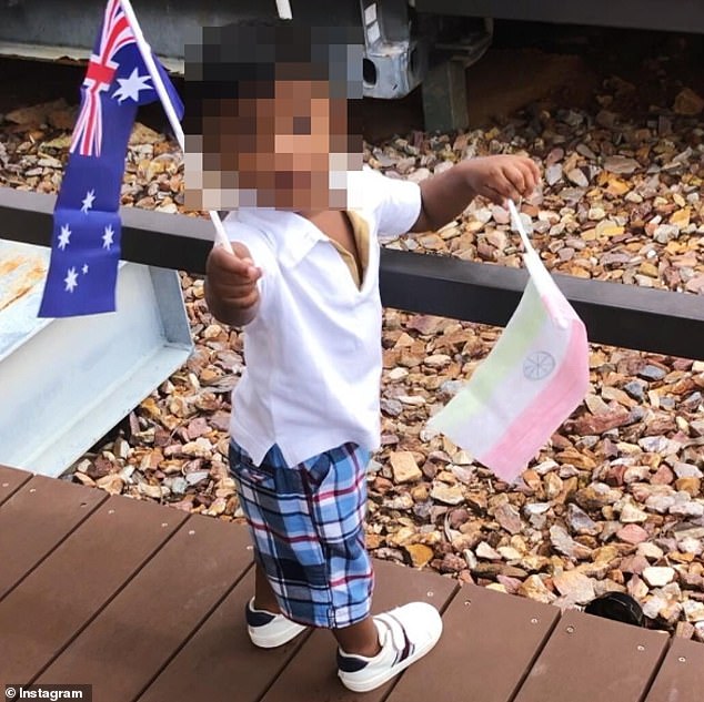 The couple's son holds up an Australian flag