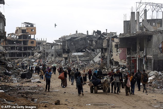 Palestinians carry or transport some personal belongings on carts as they flee Khan Yunis in the southern Gaza Strip