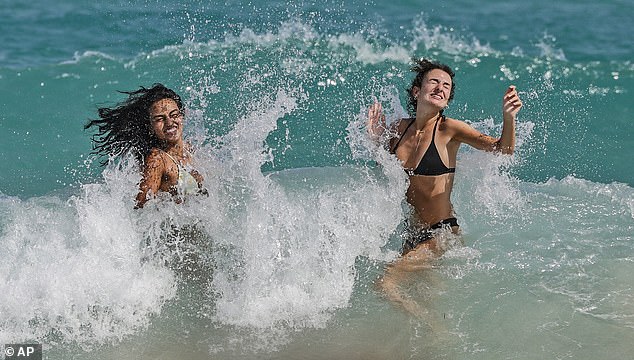 Photos from the first day of the long holiday show bikini-clad girls partying on the beach and police officers patrolling the streets in large numbers