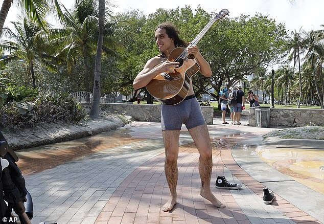 Dynamite Dynamite plays guitar for South Beach visitors during spring break in Miami Beach, Florida, Saturday, March 9, 2024