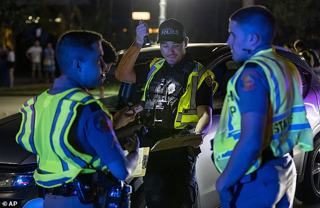 Officers work a DUI checkpoint near 5th Street and Meridian Avenue in Miami Beach, Florida during spring break, Friday, March 8, 2024