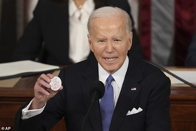 President Joe Biden, holding up a Laken Riley pin, called her an 