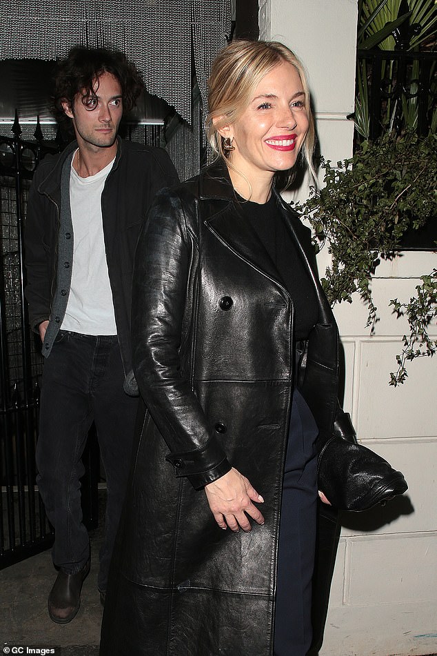 Looking effortlessly chic, the American-British actress opted for a long black leather coat for the evening, which she paired with tailored navy trousers.