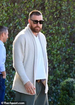 The NFL star wore a cream cardigan for the casual lunch, the day after attending an Oscars after-party