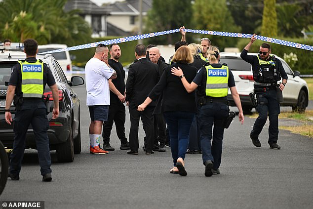 Family members were seen speaking to police at the cordoned-off crime scene