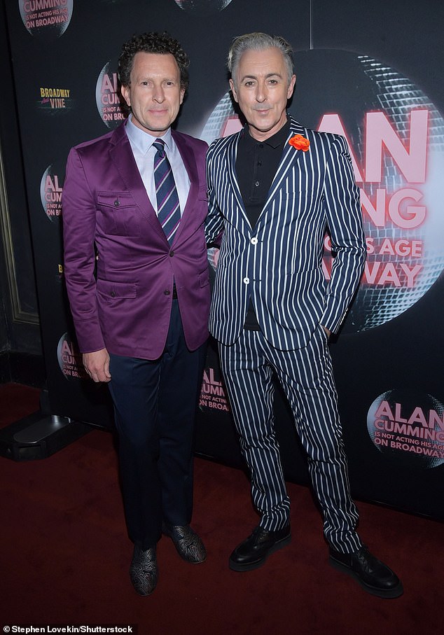 Cumming posed with Jacob Langfelder, who wore a striking purple blazer