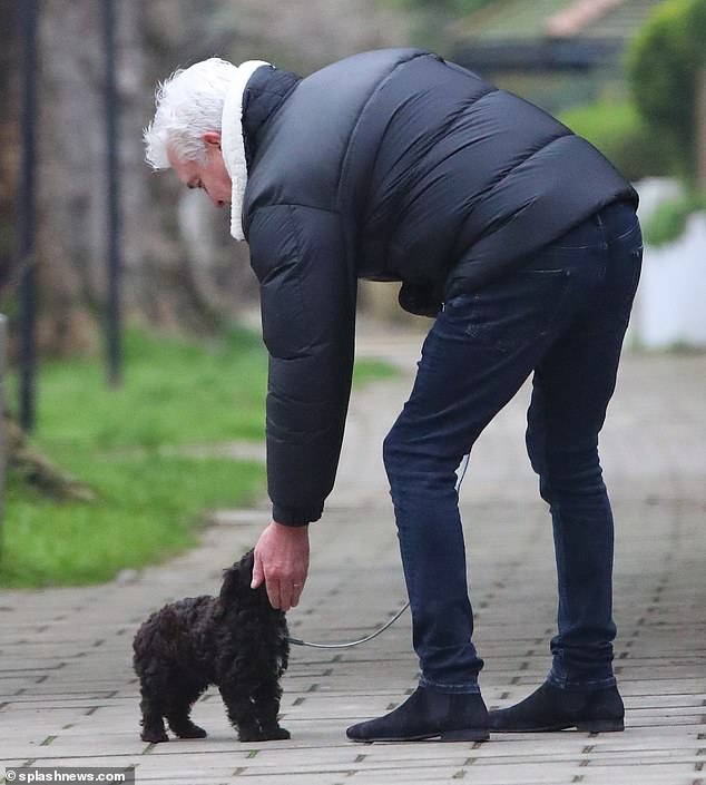 Philip leaned over to pet the cute dog