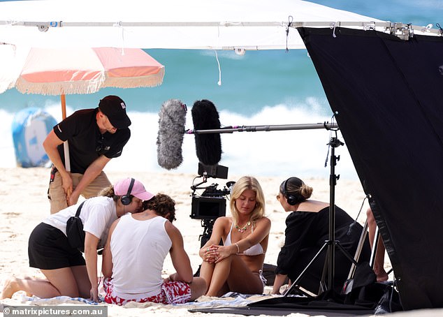 Later, a group of attractive young stars huddled on a towel, surrounded by a camera crew