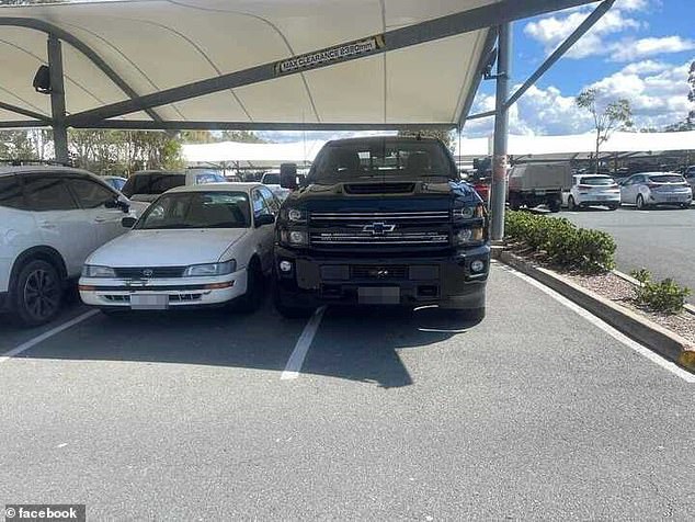 A gigantic American car is depicted taking up more than its allocated parking space