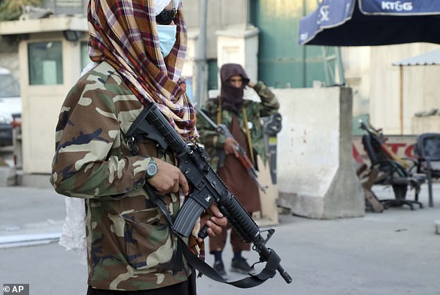 Taliban fighters stand guard at a checkpoint in Kabul, Afghanistan, Wednesday, August 25, 2021