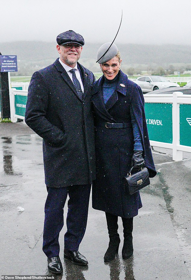 Mike wrapped his arm around Zara as he braved the rain and posed for photos in the humid conditions