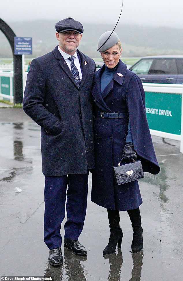 The mother-of-three wrapped up warm in a navy blue coat and a pair of trendy knee-high suede boots