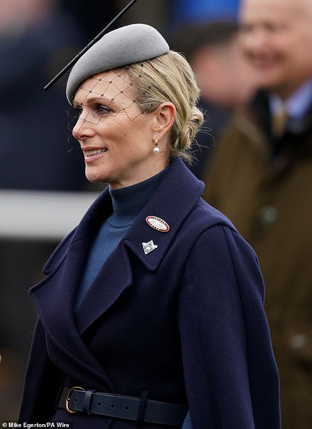 The royal looked sharp in a £369 blue cape coat from Karen Millen and a matching navy turtleneck jumper